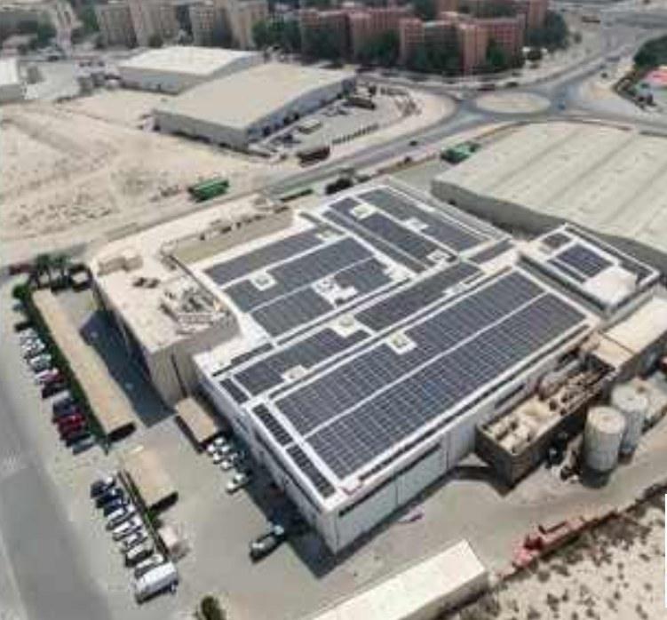 SurfaceCool coated roof with rooftop solar panels at an Emerson facility